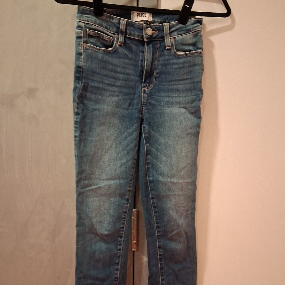 PAIGE skinny jeans featuring a classic five-pocket design and a frayed, raw-edge